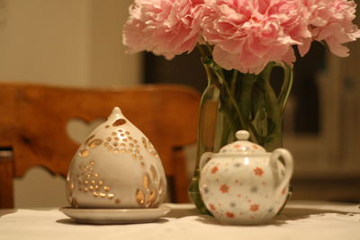 Close-up of roses in vase on table at home