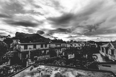 Houses against cloudy sky