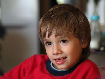 Close-up portrait of cute boy at home