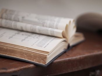 Close-up of open book on table at home