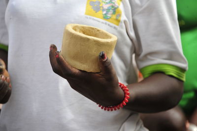 Midsection of man holding ice cream