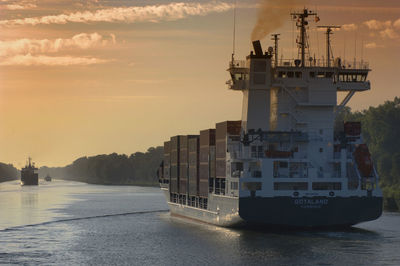 Nautical vessel on sea against sky during sunset