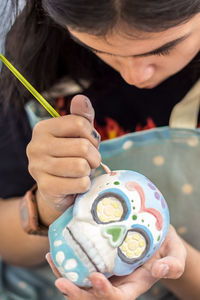 Girl painting human skull