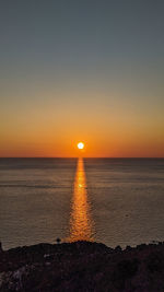 Scenic view of sea against clear sky during sunset