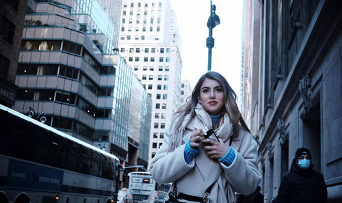 Low angle view of young woman using mobile phone