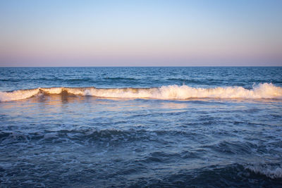 Scenic view of sea against clear sky during sunset