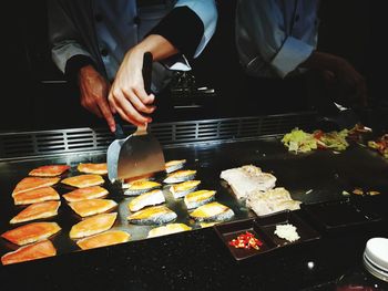 Man preparing food on barbecue grill