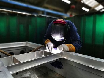 Full length of man working in factory