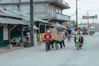 People walking on road in city