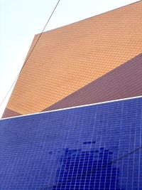 Low angle view of roof of building against blue sky