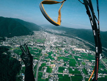 Person paragliding above city