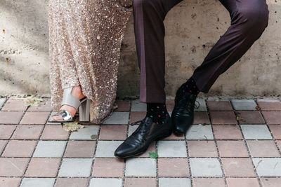 Low section of couple sitting outdoors