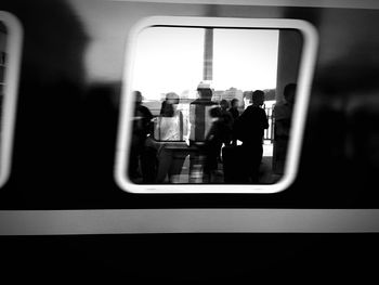 Reflection of people on train window