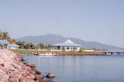 Scenic view of sea and mountains against sky