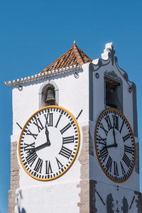 Low angle view of clock tower against clear sky