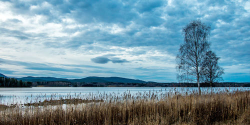 Scenic view of lake against cloudy sky