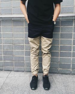 Low section of man standing on tiled floor