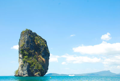 Rock formation in sea against sky