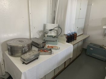 High angle view of old machine on table against wall