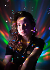 Portrait of woman in illuminated nightclub