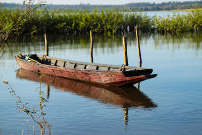 Abandoned boat moored in lake