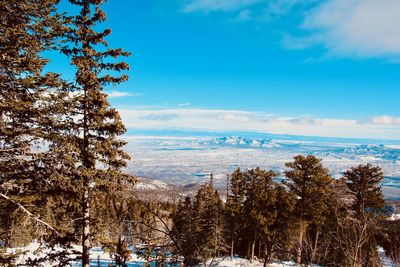 Scenic view of snowcapped mountains against blue sky