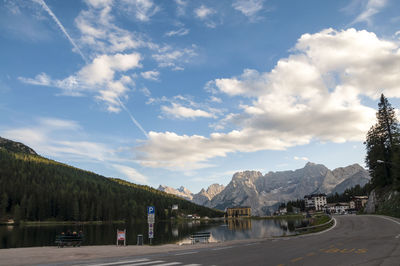 Road by mountains against sky