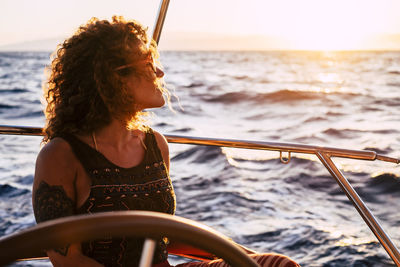 Woman looking at sea against sky