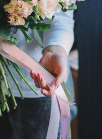 Close-up of hand holding flower bouquet