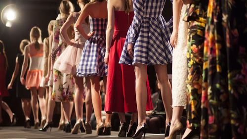 Rear view of fashion models in backstage