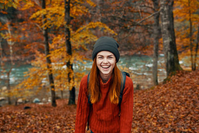 Portrait of smiling woman wearing knit hat during autumn