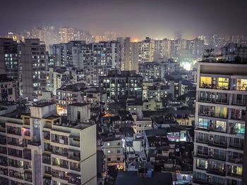 High angle view of illuminated buildings in city at night. 