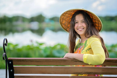 Portrait of smiling girl wearing straw hat