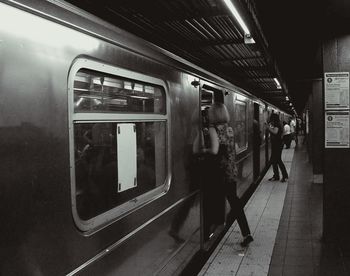 Man in train at railroad station