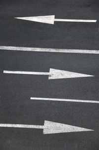 High angle view of arrow symbols on road