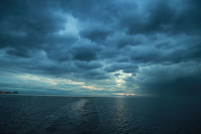 Scenic view of sea against storm clouds