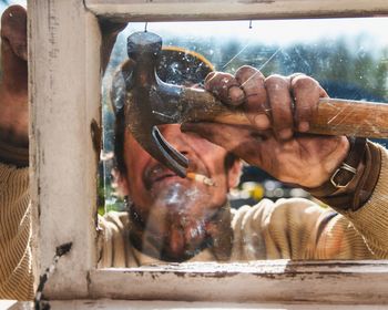 Close-up of man changing the window glass