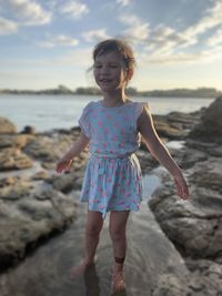 Full length of girl standing on beach