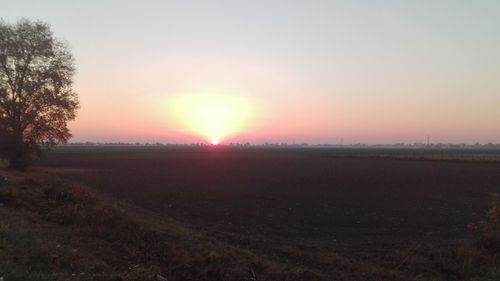 Scenic view of field against sky during sunset