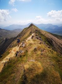 Hiker on mountain against sky