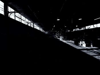 Silhouette of illuminated bridge at night