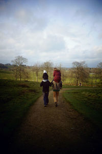 Full length of woman walking on grassy field