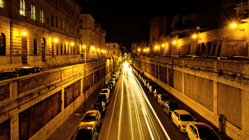 Illuminated road in city at night