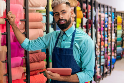 Portrait of young man standing in store