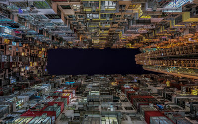 Directly below shot of residential buildings against clear sky at night