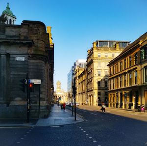 City street and buildings against sky