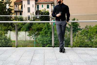 Low section of man standing in front of building
