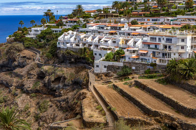 High angle view of townscape by sea