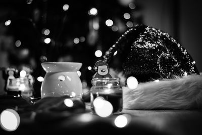 Close-up of illuminated tea light candles on table