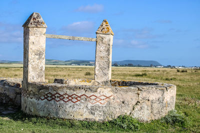 Old ruins on field against sky